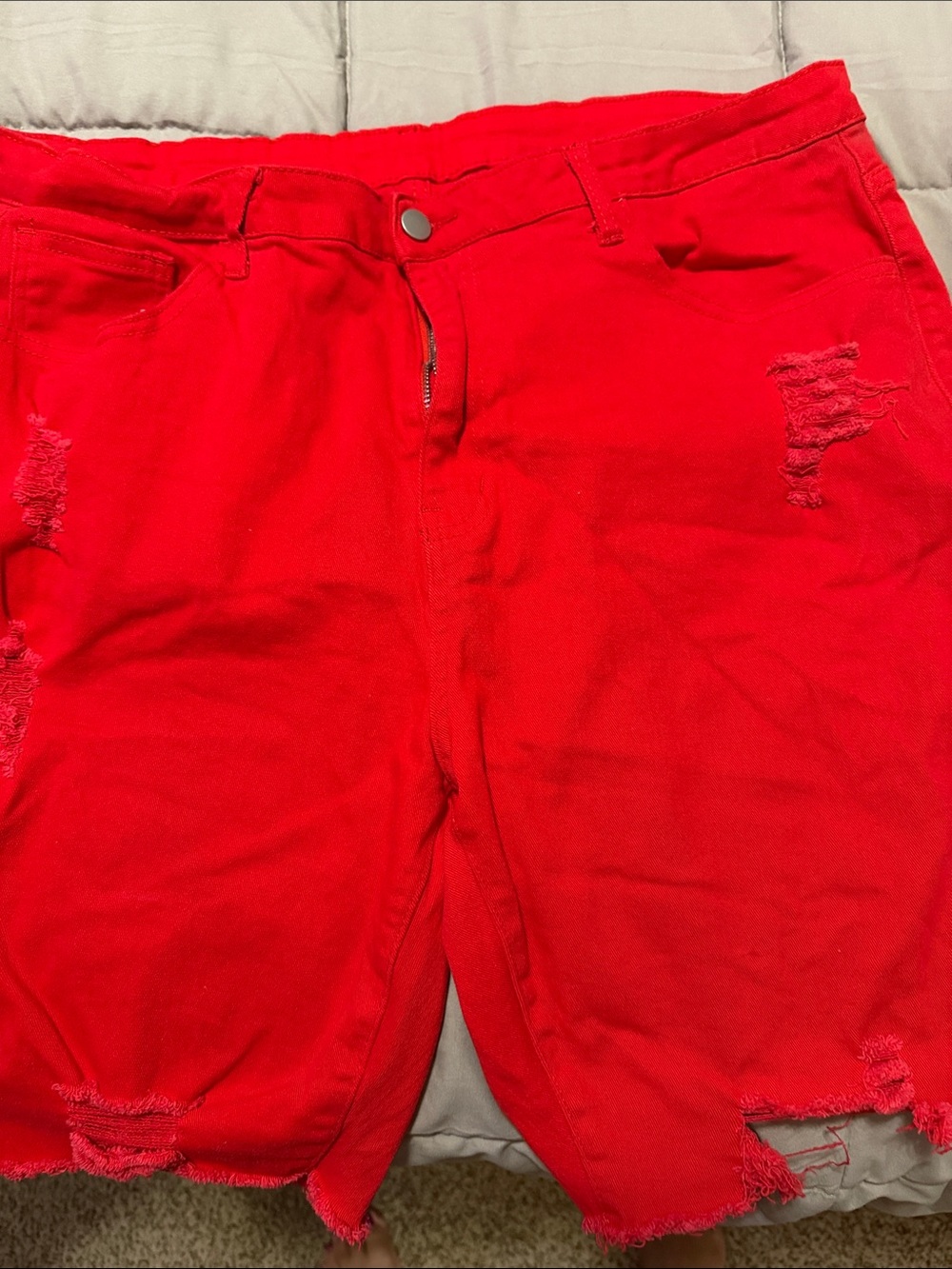 Woman’s Candy Apple Red SHEIN Stretch Jean Shorts.